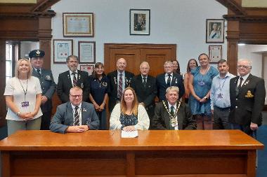 Cllr Susan Wallwork, centre, signs the covenant with representatives of the council and Armed Forces Community.