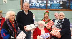 MP Steve Barclay helping Santa to hand out gifts generously donated by the Fenland community, at the December Golden Age event in Wisbech.