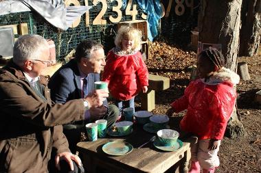 Phillip Ansell, chairman of Glassmoor Local Environment Fund committee, left, and Park Lane Primary and Nursery School executive headteacher Rob Litten toast the new mud kitchen, with Gracie and Hailey.